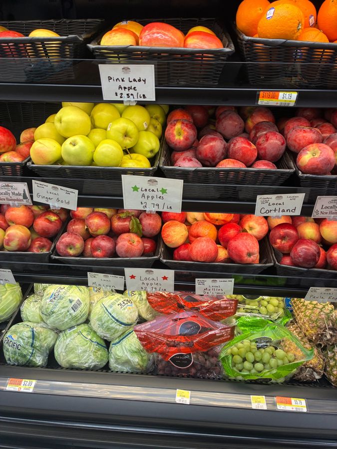 An assortment of apples and other fresh produce in the market