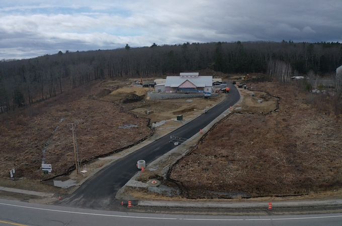 An aerial view of the driveway and building under construction