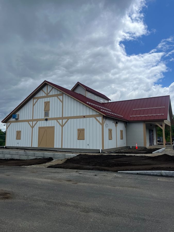 Siding and landscaping work at the market before opening