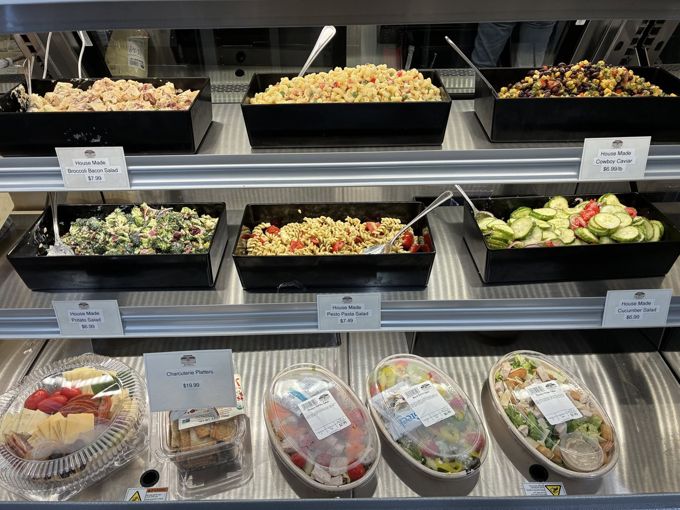 A deli case with house-made salads and prepared trays