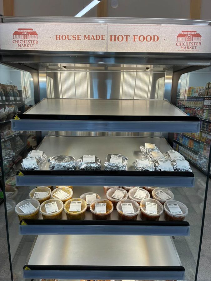 Hot-food display with wrapped sandwiches and containers