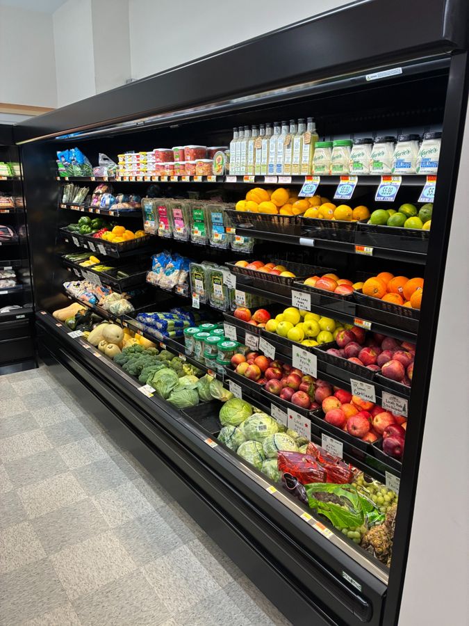The full produce case with fruits, vegetables and greens