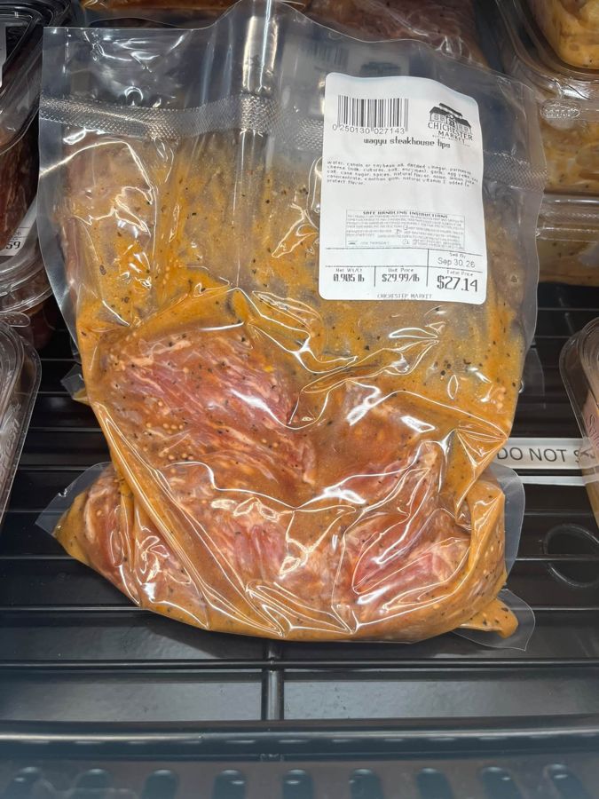 A package of marinated steak tips in the meat case