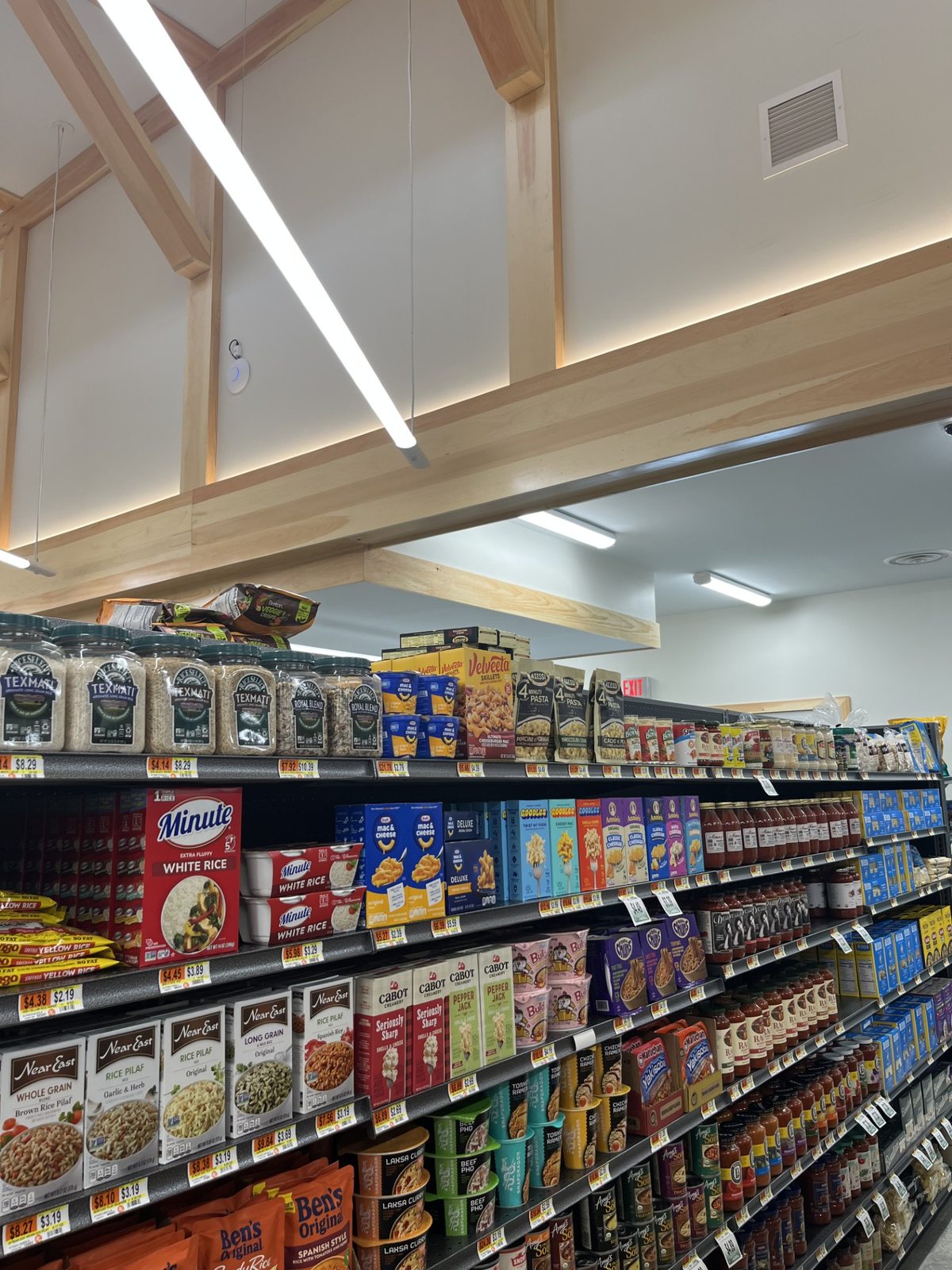 Grocery shelves stocked with pantry staples, sauces, and seasonings
