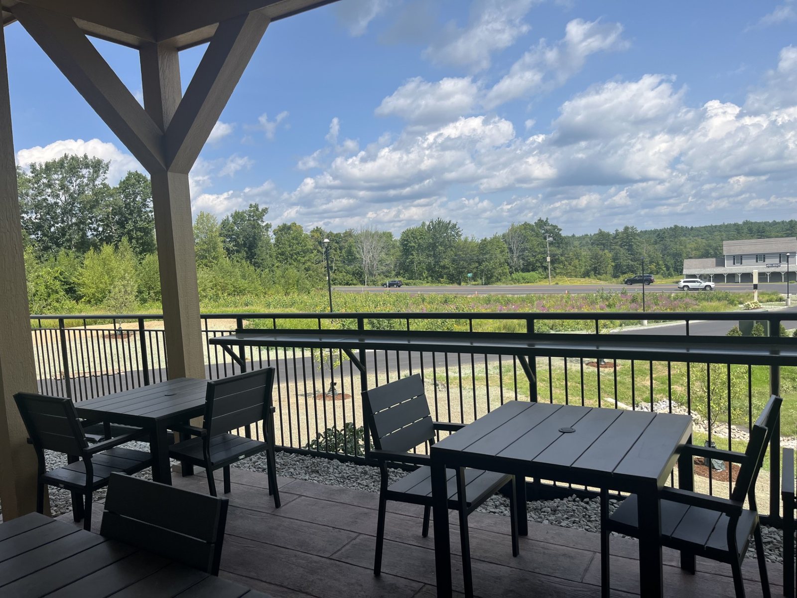 Outdoor patio seating at Chichester Market overlooking Route 4